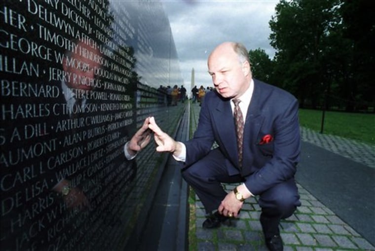 John Wheeler III touches the name of a friend engraved in the Vietnam Veterans Memorial in Washington in 1994.